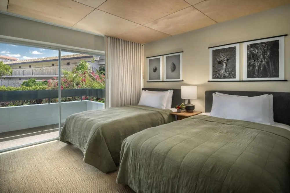 Garden View Two guest room with two beds and balcony at PACIFIC 19 Kona.