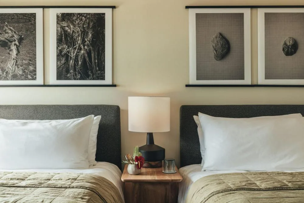 Garden View Two beds with bedside table and wall art at PACIFIC 19 Kona.