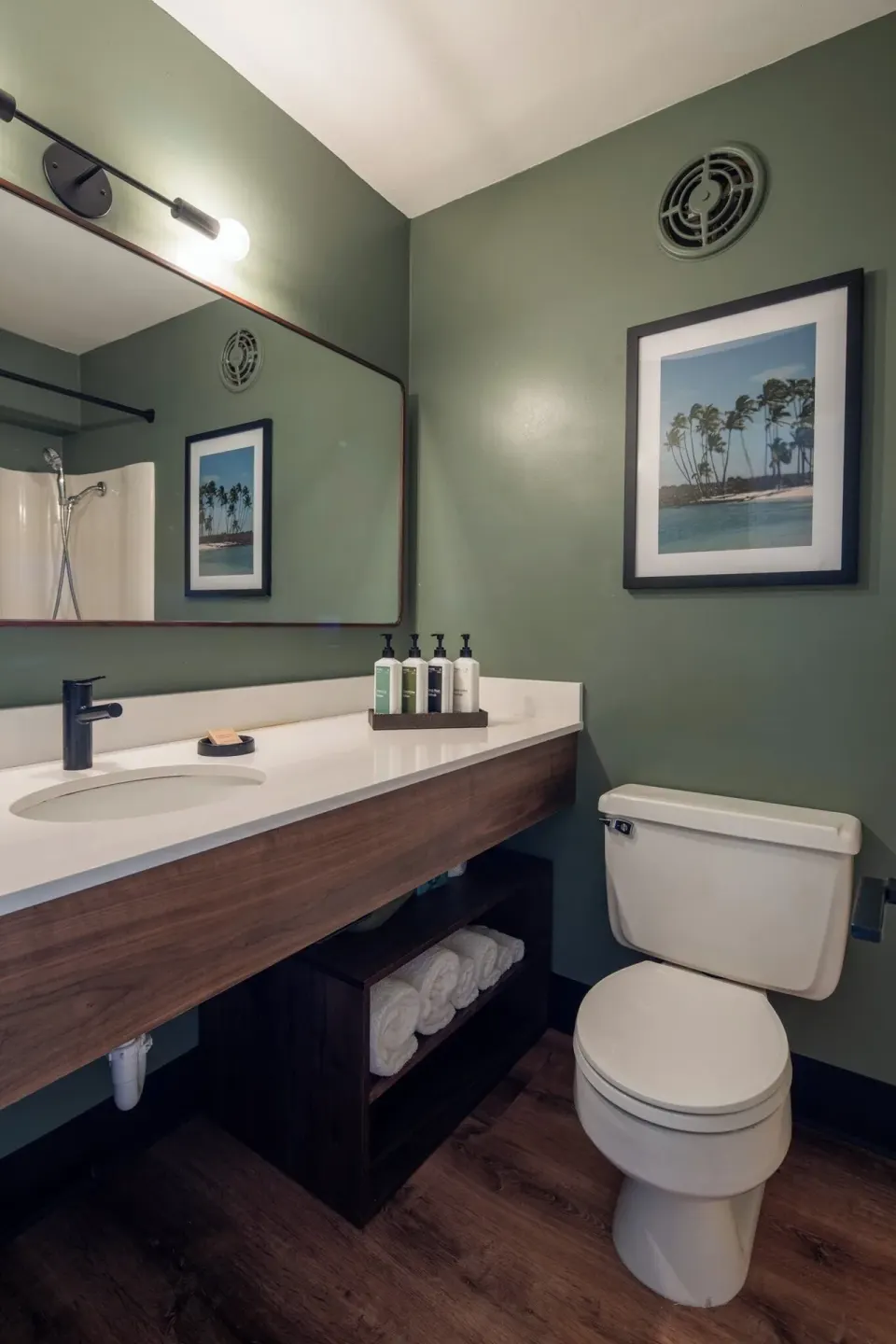 Pool View room bathroom with vanity, mirror, toilet, and shower at PACIFIC 19 Kona.