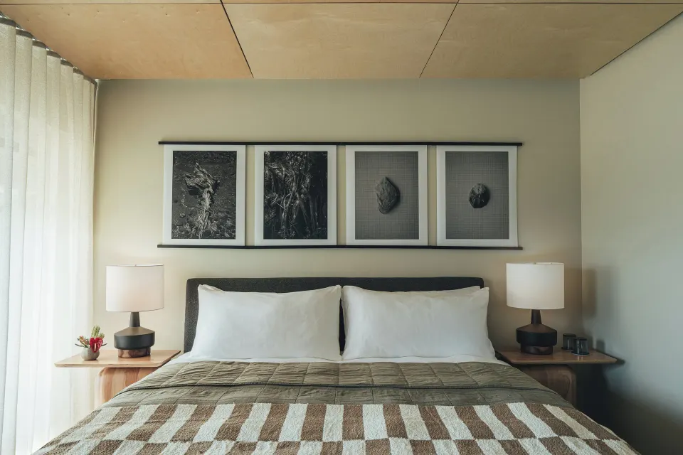 Pool View room king bed with bedside lamps and wall art at PACIFIC 19 Kona.