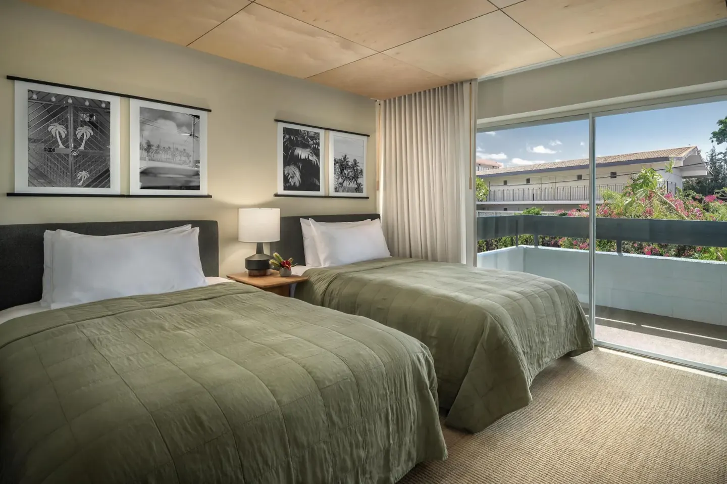 Two-bed guest room with balcony and tropical artwork at PACIFIC 19 Kona.