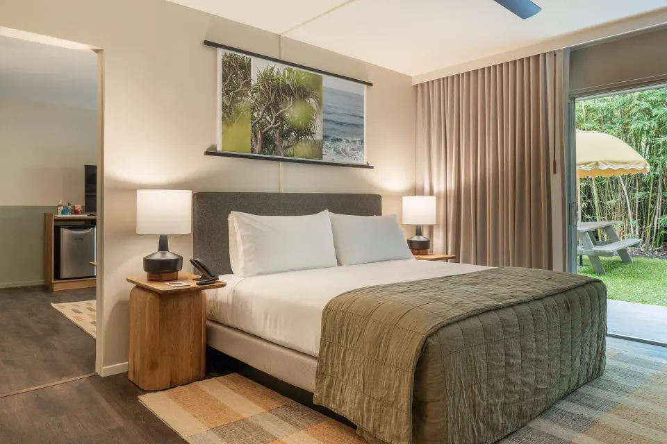 Suite Ohana king bed with patio view at PACIFIC 19 Kona.