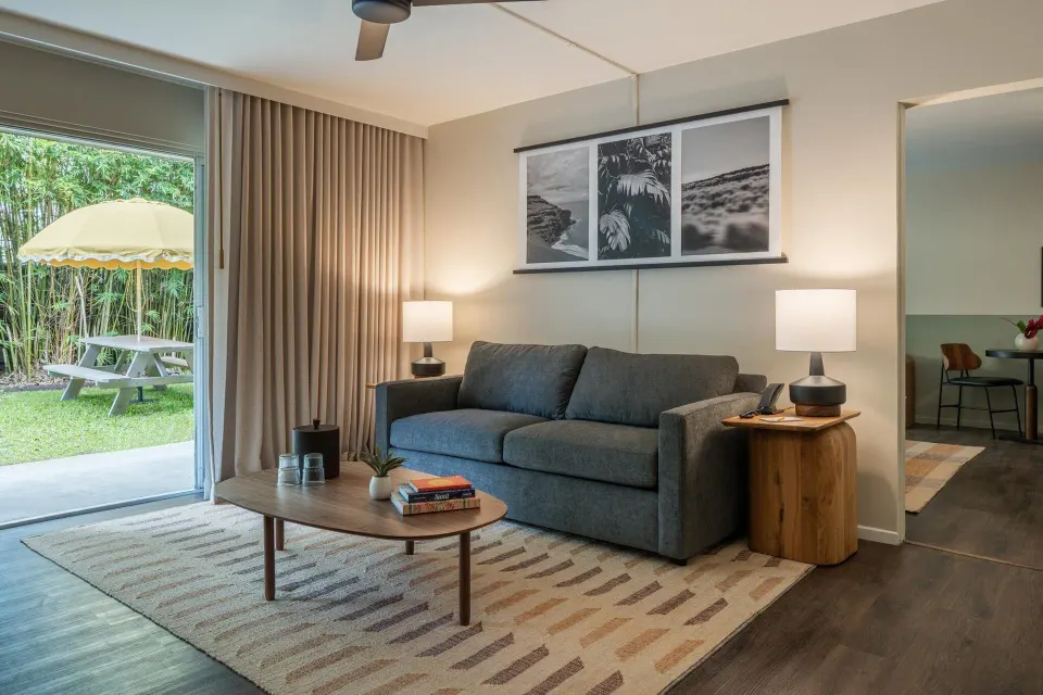 Suite Ohana living area with sofa and patio at PACIFIC 19 Kona.
