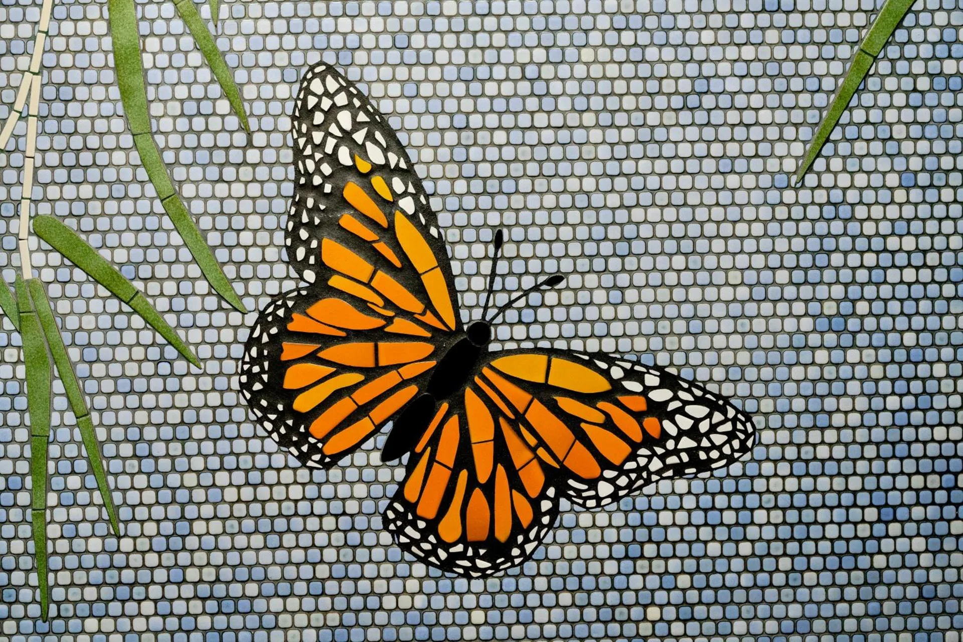 Butterfly mosaic detail on a tiled wall at Pacific Monarch Hotel.