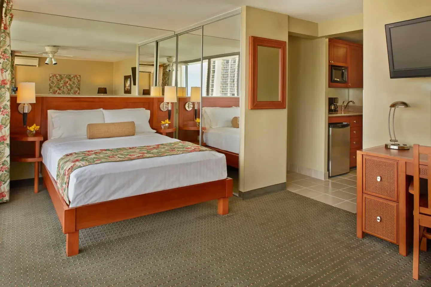 Guest room with king bed and kitchenette at Pacific Monarch Hotel.