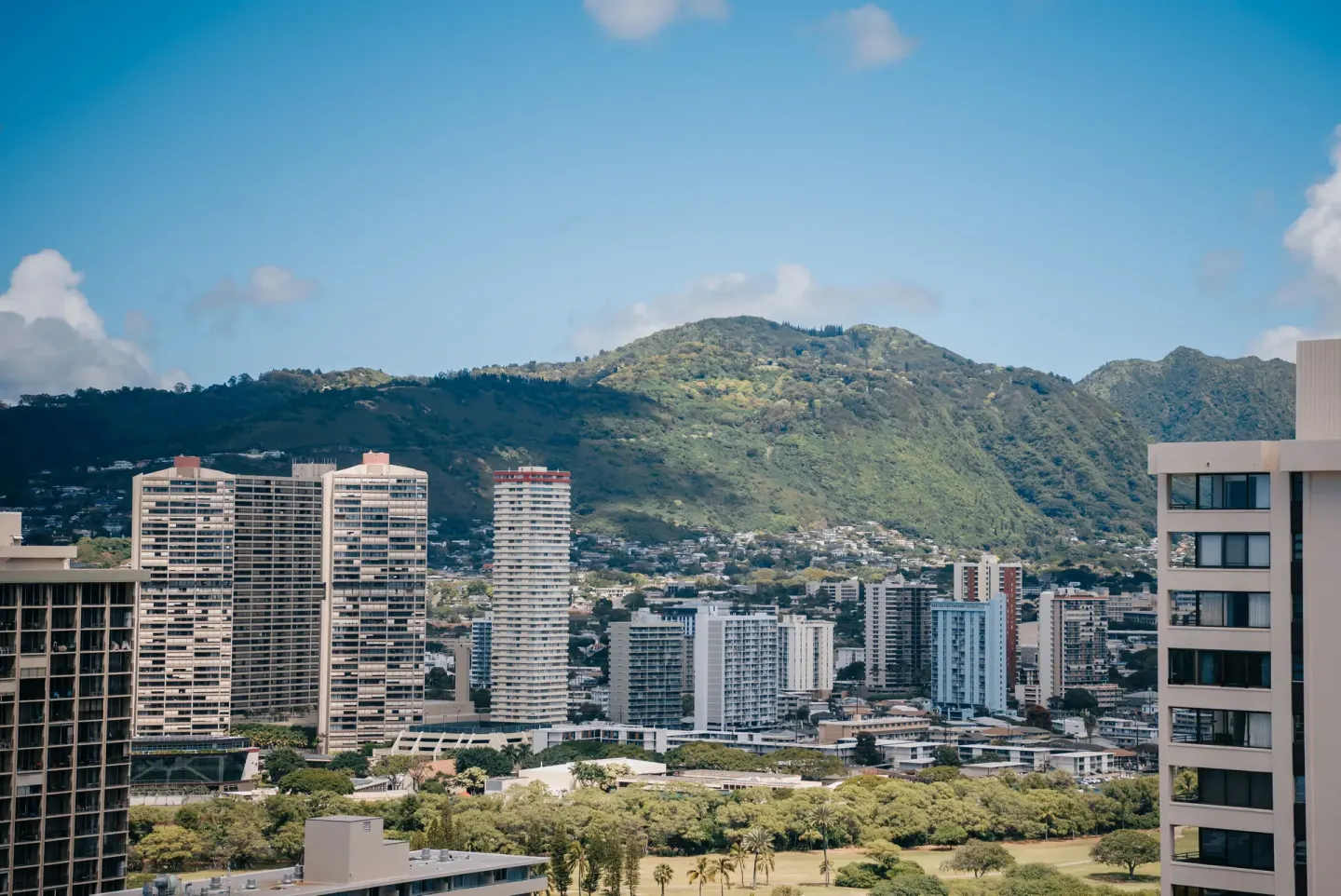 City high-rises and green mountains viewed from Pacific Monarch Hotel.