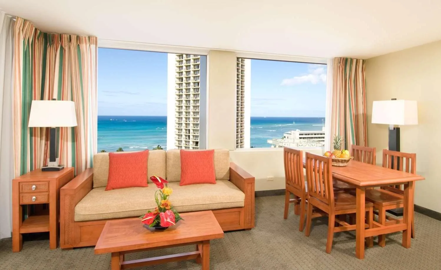 Ocean-view living and dining area in a suite at Pacific Monarch Hotel.
