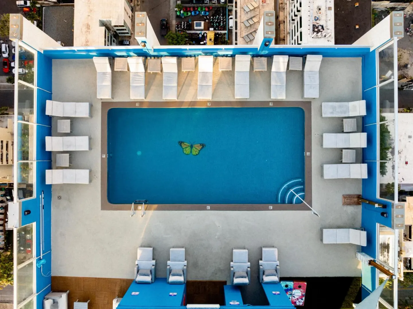 Overhead view of the rooftop pool deck and loungers at Pacific Monarch Hotel.