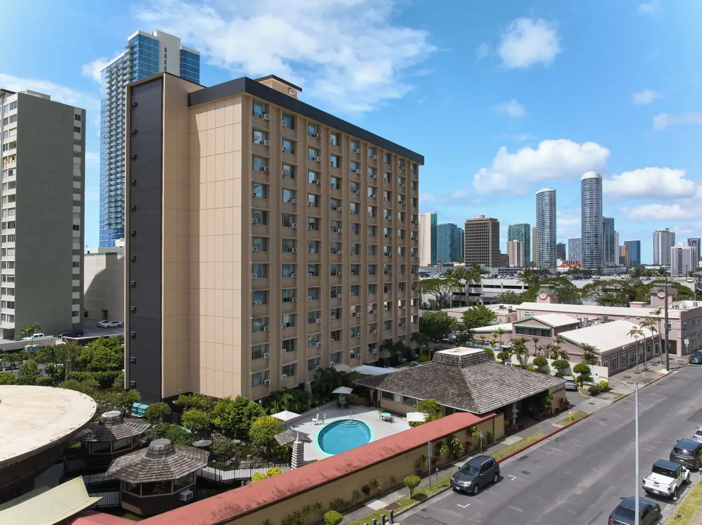 Exterior tower, pool courtyard, and city skyline at Pagoda Hotel.