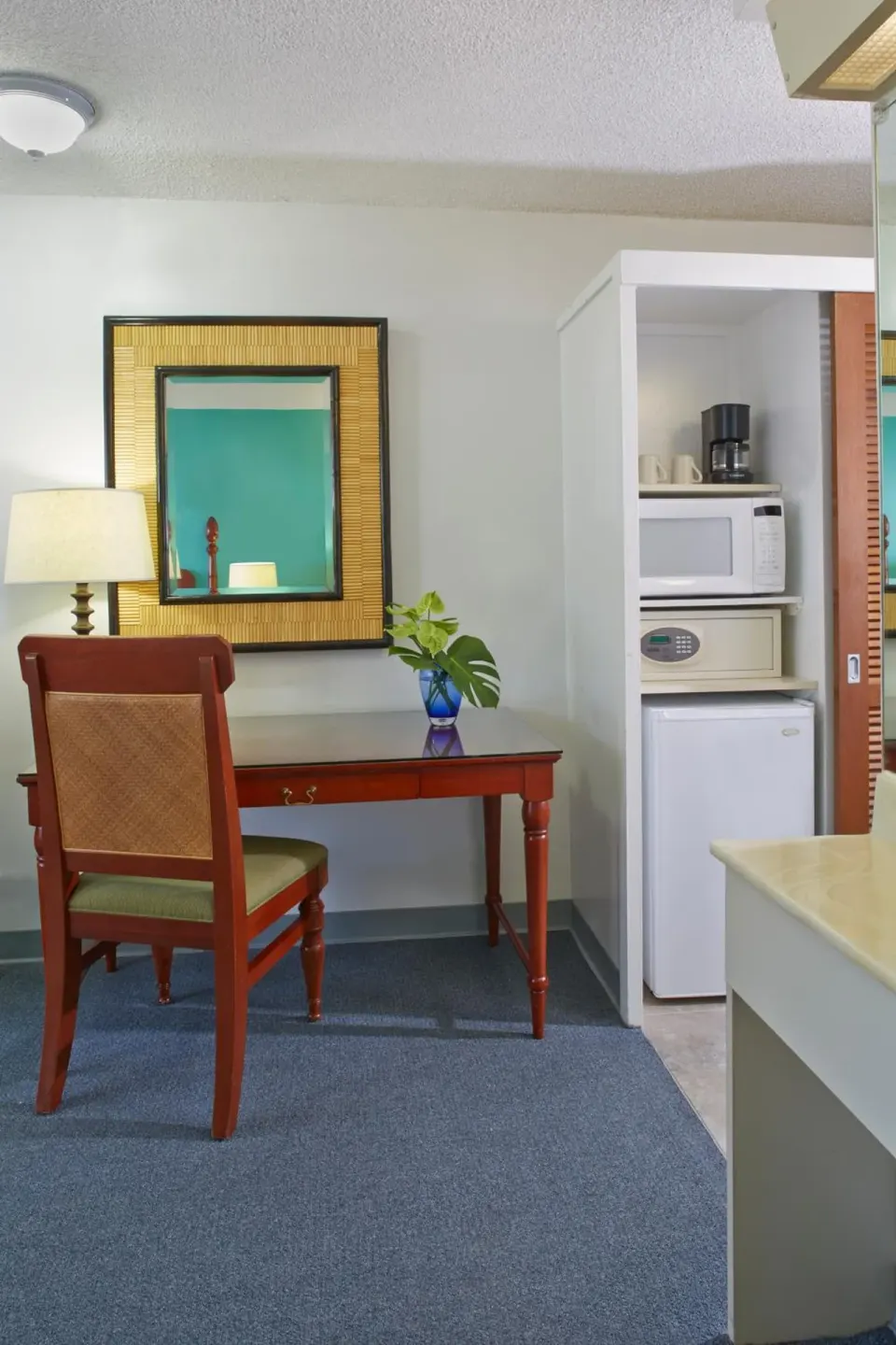 Guest room desk and kitchenette area at Pagoda Hotel.
