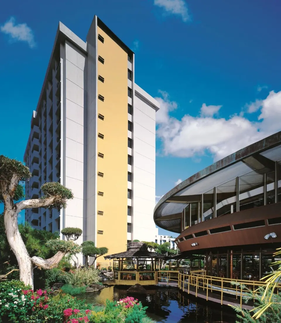 Hotel tower, pond, and floating restaurant building at Pagoda Hotel.