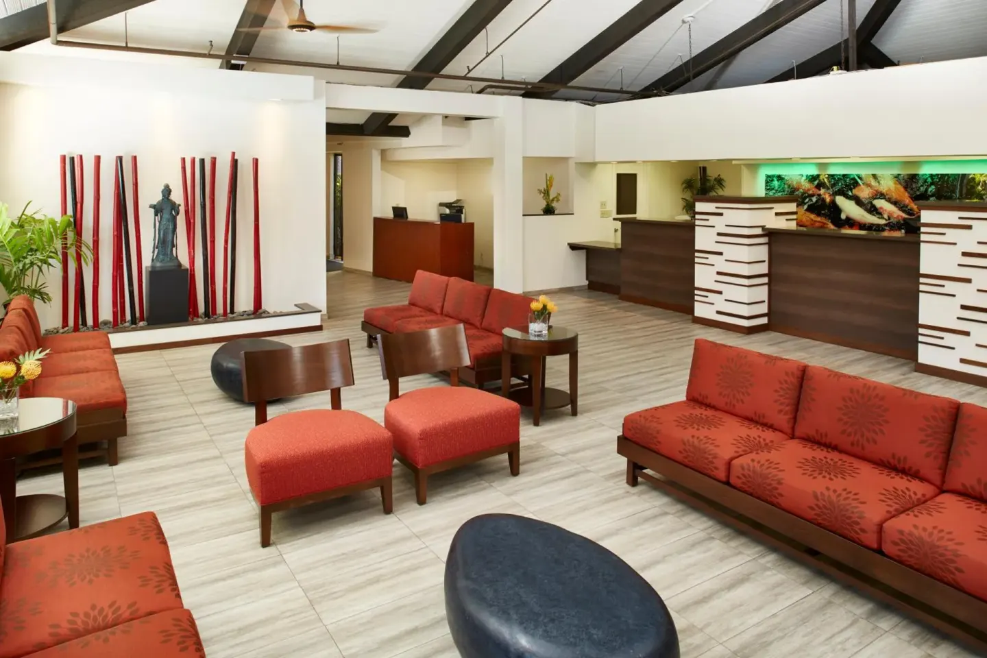 Lobby reception area with red seating and front desk at Pagoda Hotel.