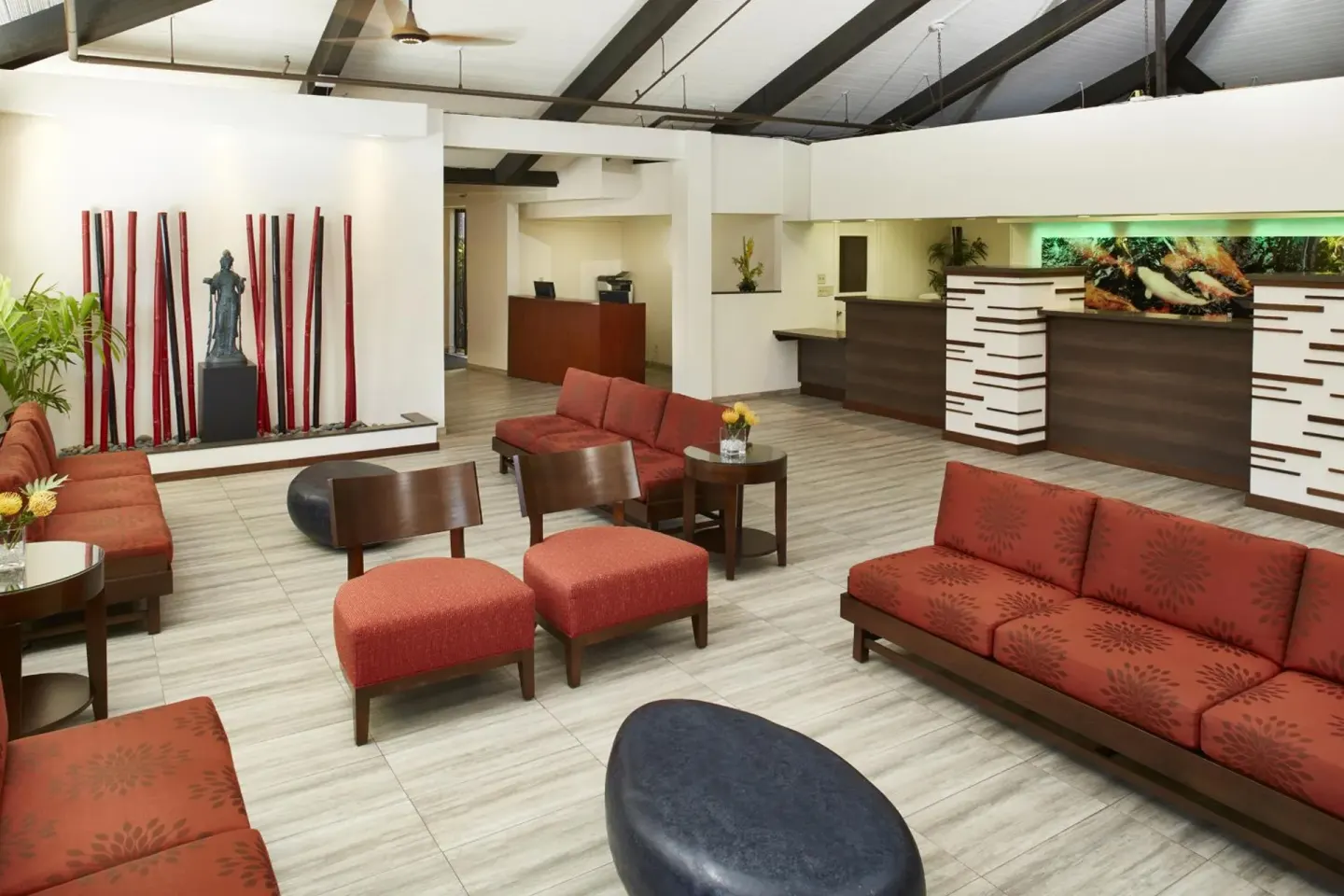 Lobby seating area with red sofas and reception desks at Pagoda Hotel.