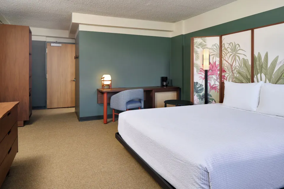 City View guest room with king bed, desk, and tropical headboard at Pagoda Hotel.
