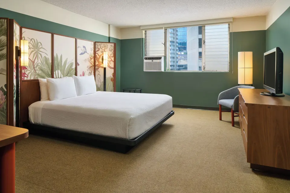 City View room with a king bed, wall art, desk, TV, and window at Pagoda Hotel.