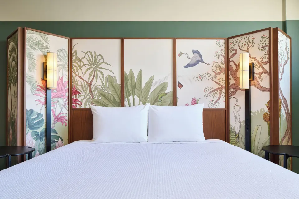 King bed with tropical screen headboard and bedside lamps in a City View room at Pagoda Hotel.