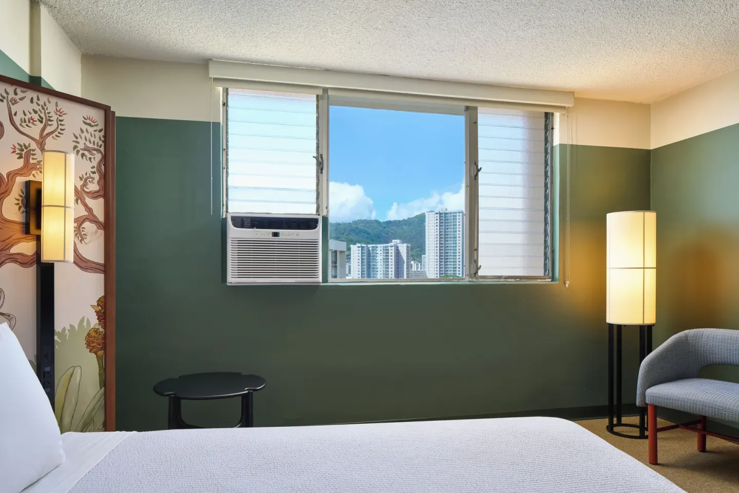 City View room window with skyline and hillside view above the bed at Pagoda Hotel.