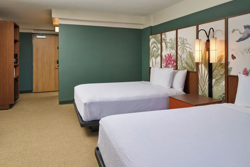 City View room with two beds, tropical headboards, and entry door at Pagoda Hotel.