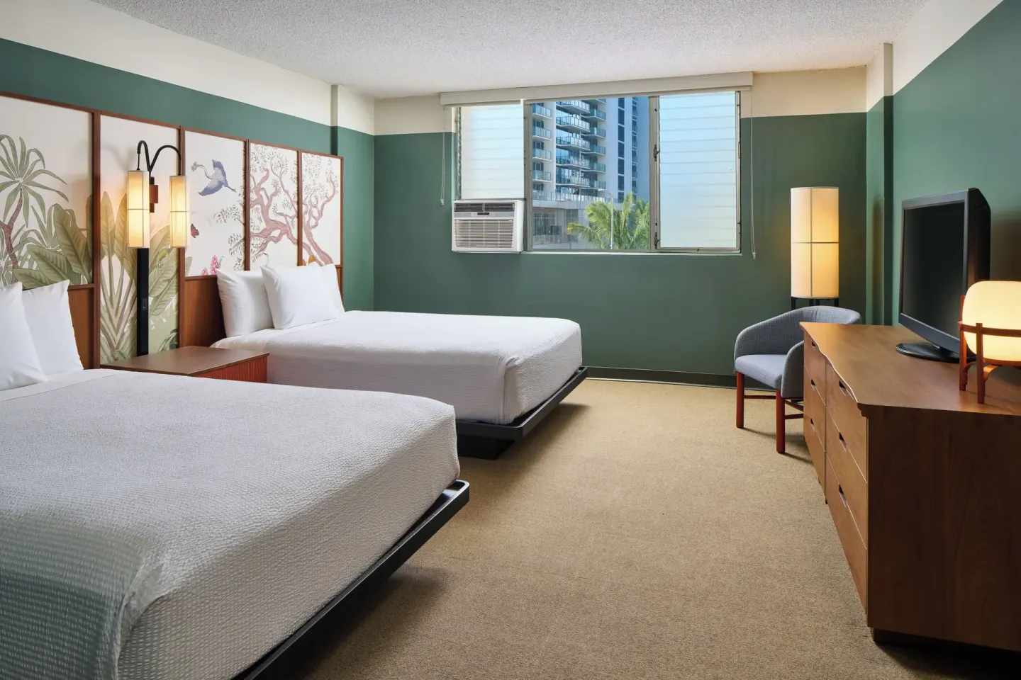 City View room with two beds, window, seating, dresser, and TV at Pagoda Hotel.