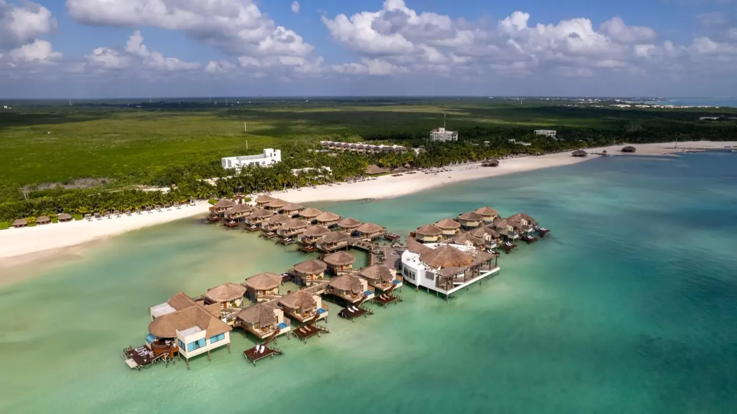 Aerial view of overwater bungalows and beach at Palafitos Overwater Bungalows.