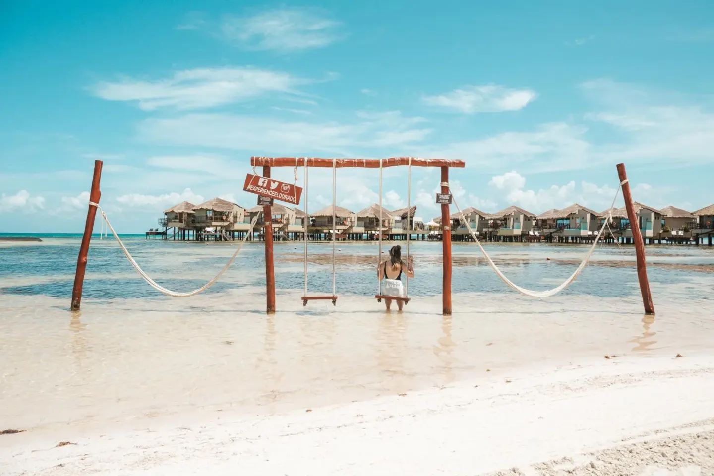 Beach swing facing overwater bungalows at Palafitos Overwater Bungalows.