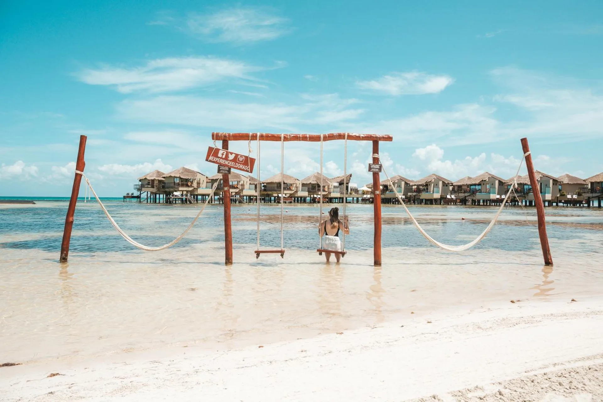Beach swing facing overwater bungalows at Palafitos Overwater Bungalows.