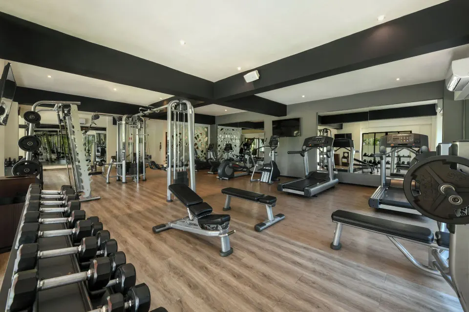 Fitness center with treadmills, weights and benches at Palafitos Overwater Bungalows.