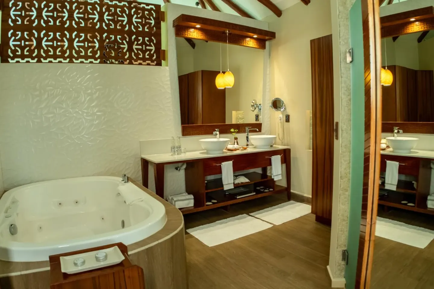 Bathroom with soaking tub and double vanity at Palafitos Overwater Bungalows.