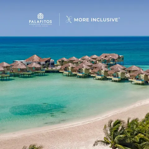 Aerial view of overwater bungalows and beach at Palafitos Overwater Bungalows.