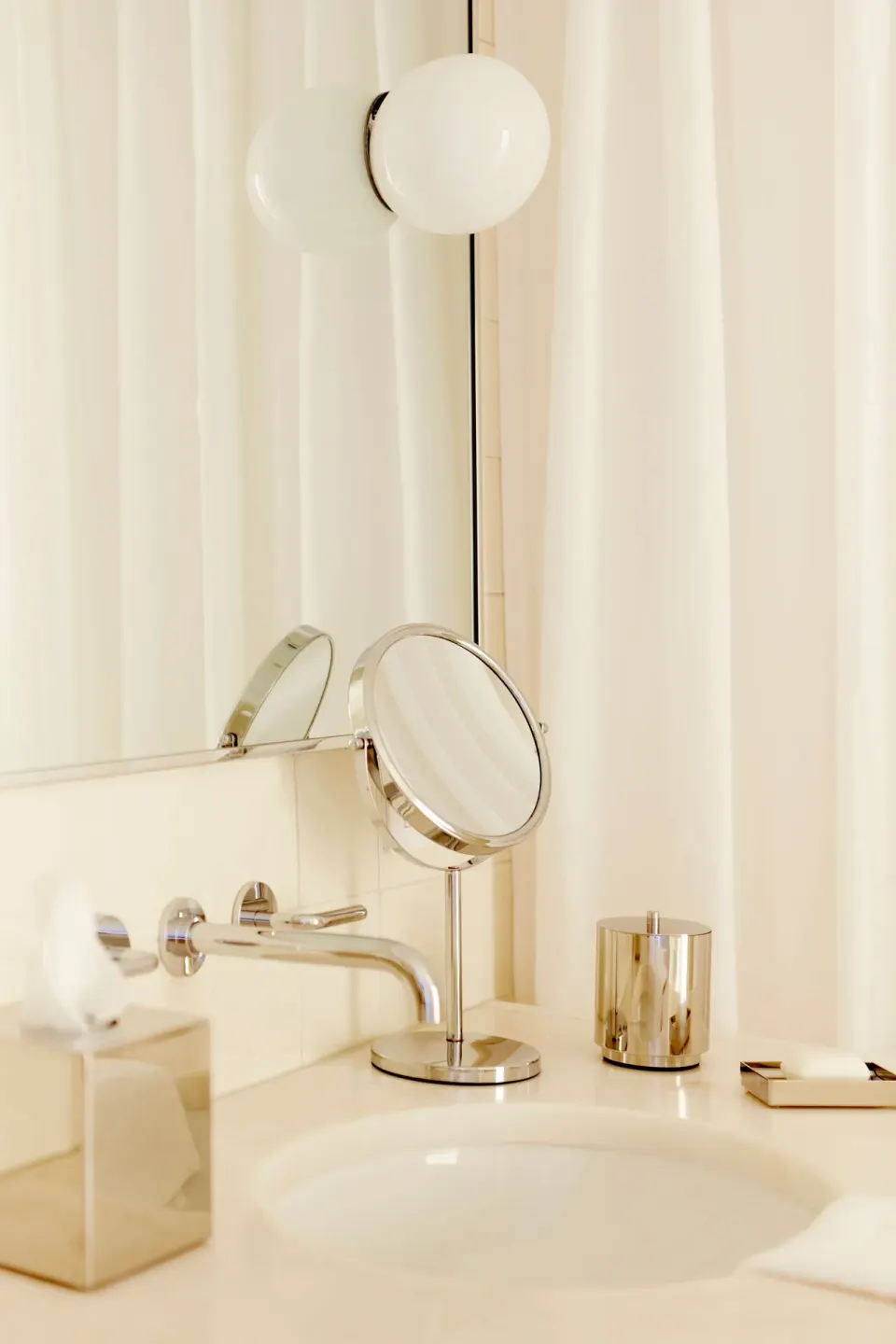 Bathroom vanity sink with mirror and polished fixtures at Palm Heights.