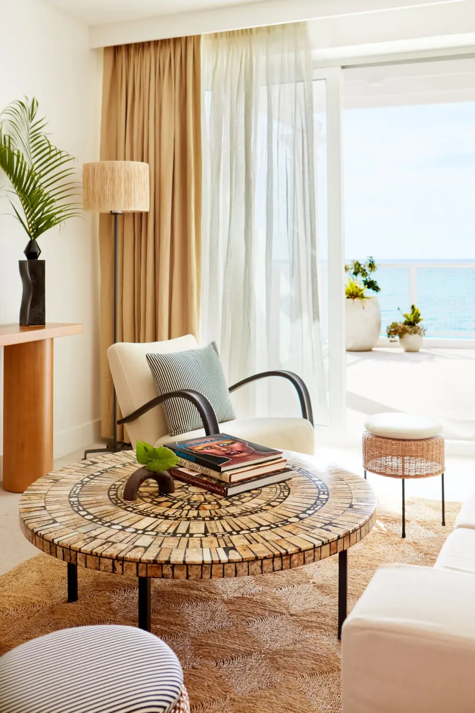 Seating corner in a suite with mosaic coffee table and ocean light at Palm Heights.