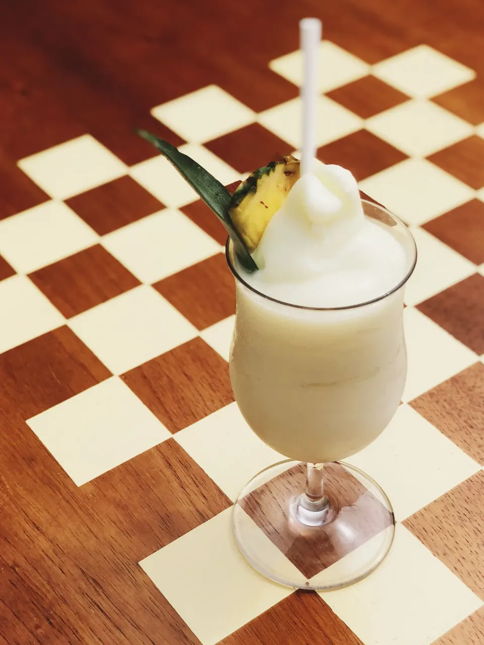 Frozen pineapple cocktail garnished with pineapple at Palm Heights