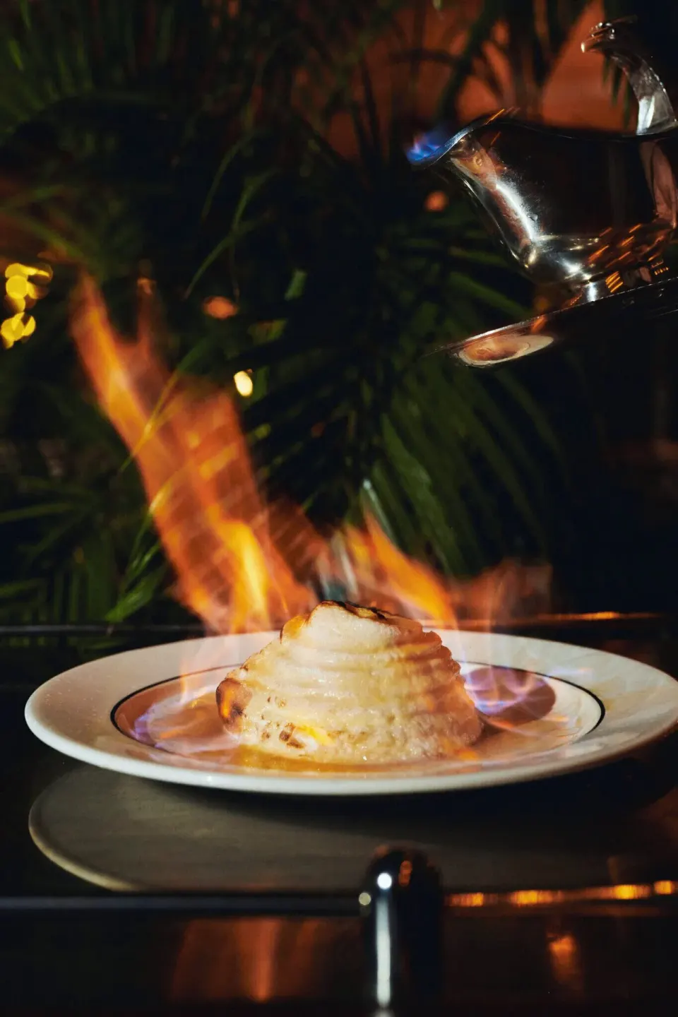 Flaming baked dessert being finished tableside at Palm Heights dining