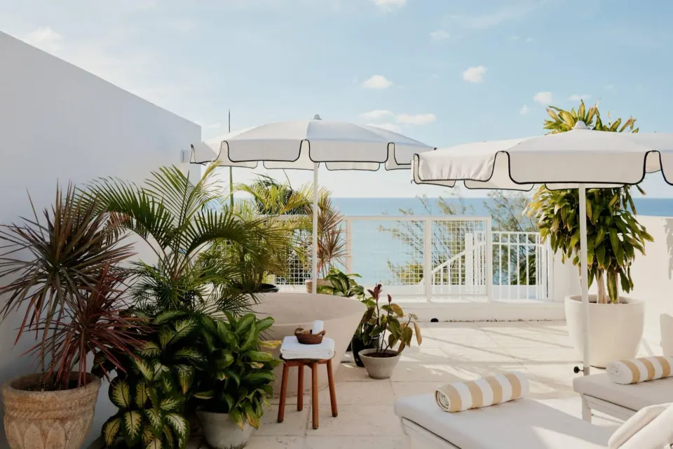 Private terrace with sun loungers and umbrellas at Palm Heights