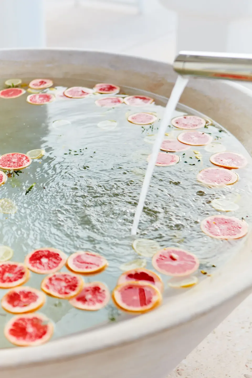Close-up of round tub with citrus slices floating in the water at Palm Heights