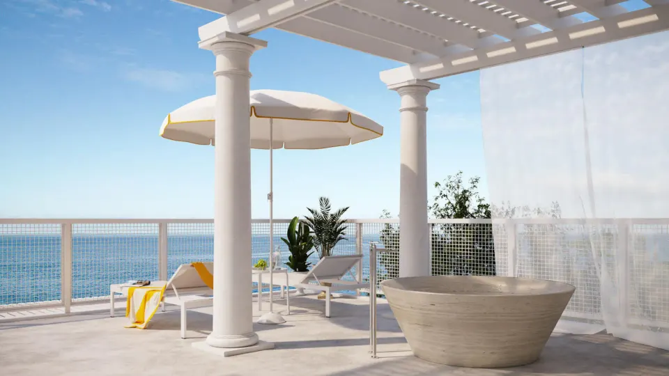Terrace loungers, umbrella and tub on a beachfront balcony at Palm Heights