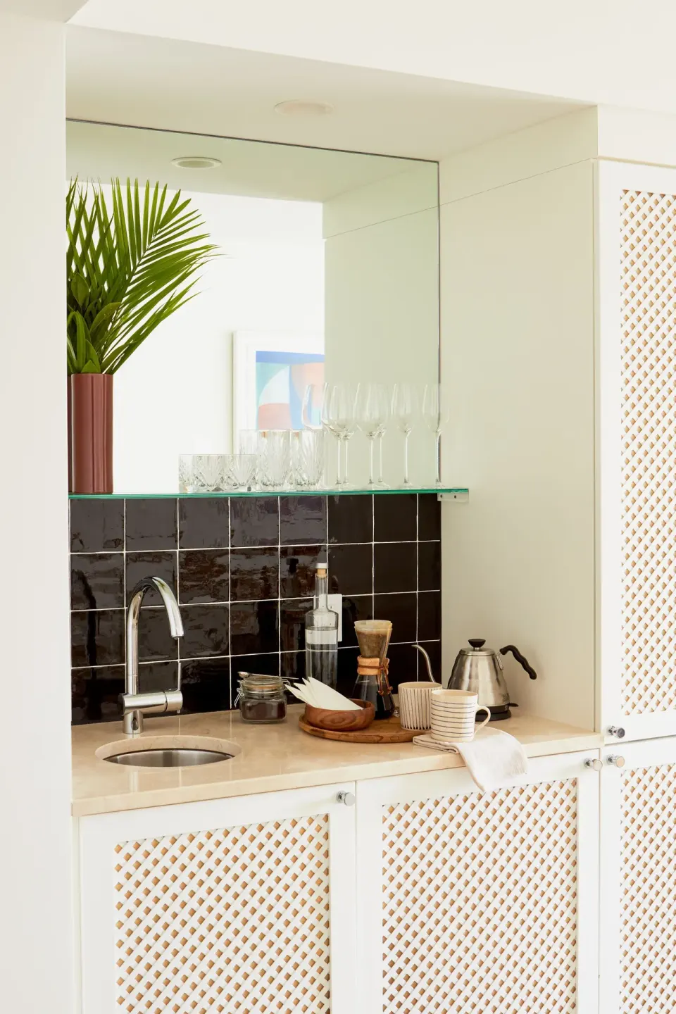 Kitchenette counter with sink, glassware and kettle in an Ocean View Suite at Palm Heights