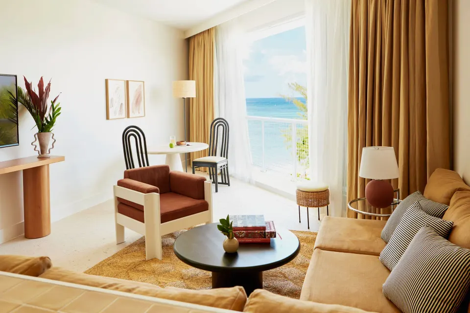Ocean View Suite living area with seating and balcony at Palm Heights