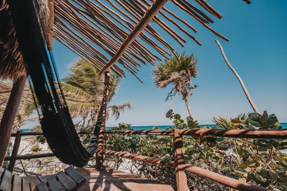 Shaded deck with hammock and ocean view at Papaya Playa Project.
