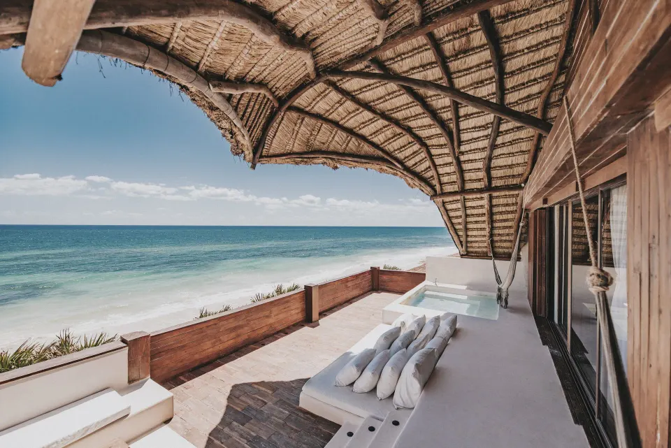 Oceanfront terrace with built-in daybeds and plunge pool at Papaya Playa Project