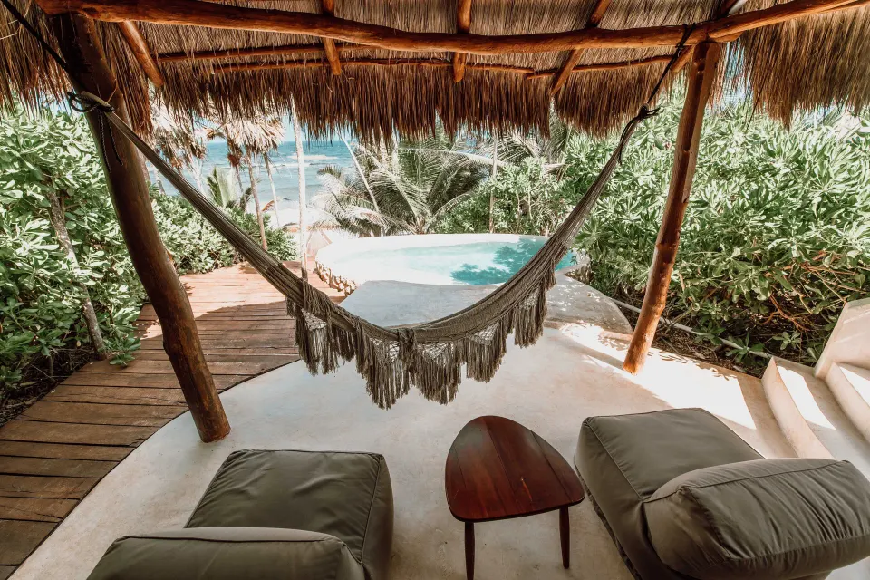 Hammock over a shaded terrace with a private plunge pool and ocean view at Papaya Playa Project.