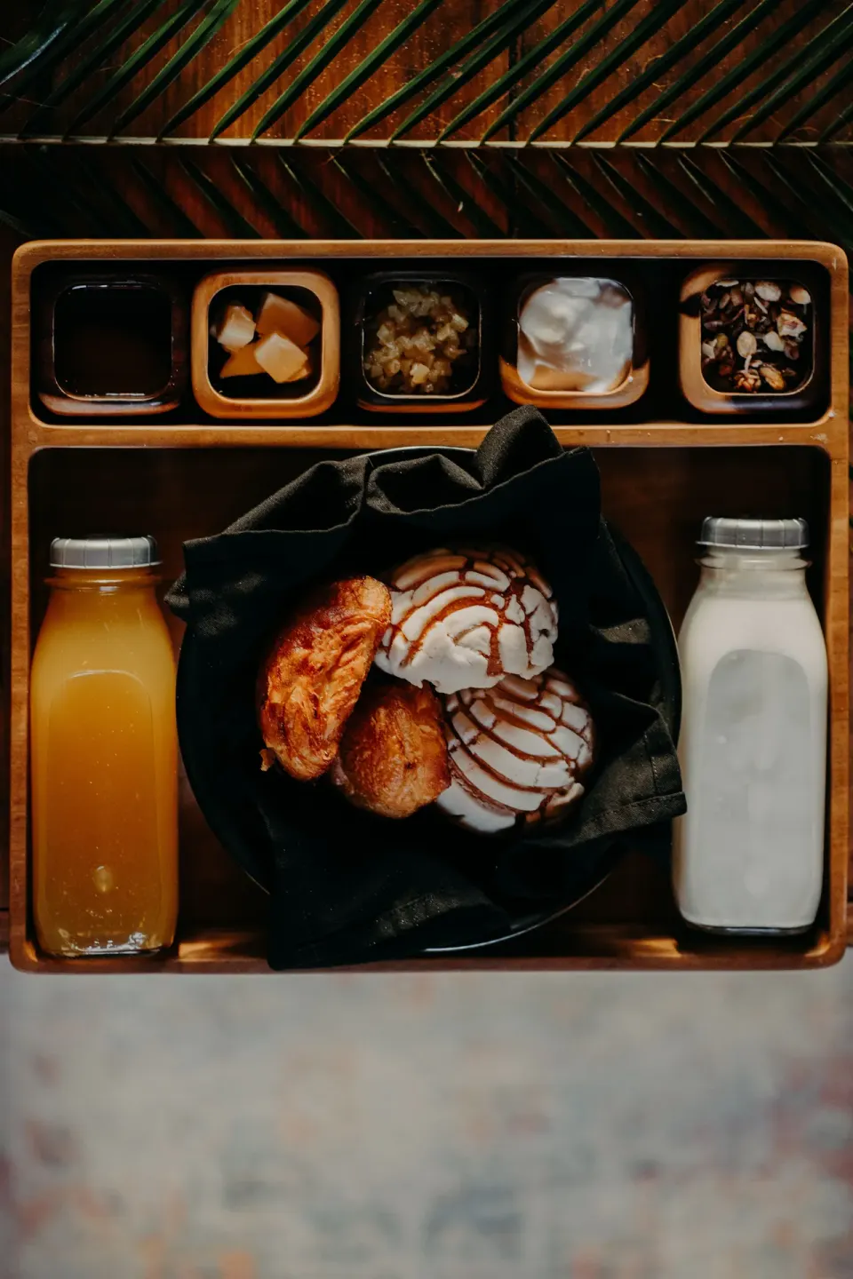 Breakfast tray with pastries, juice and milk at Papaya Playa Project