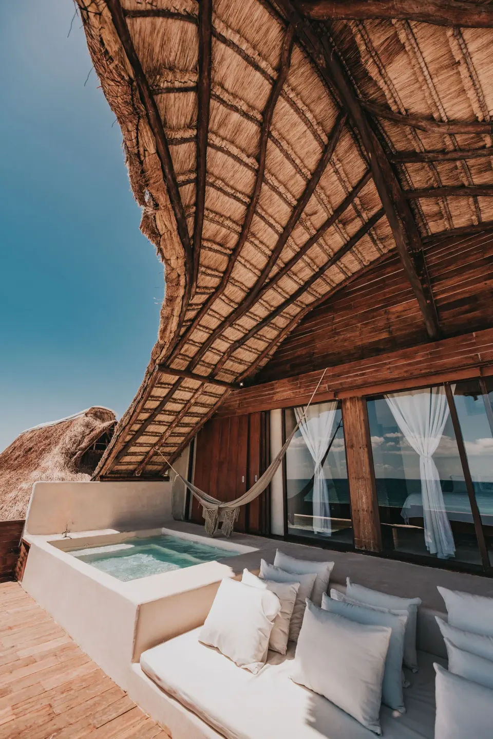 Shaded rooftop seating and private hot tub on Casa Palapa terrace at Papaya Playa Project