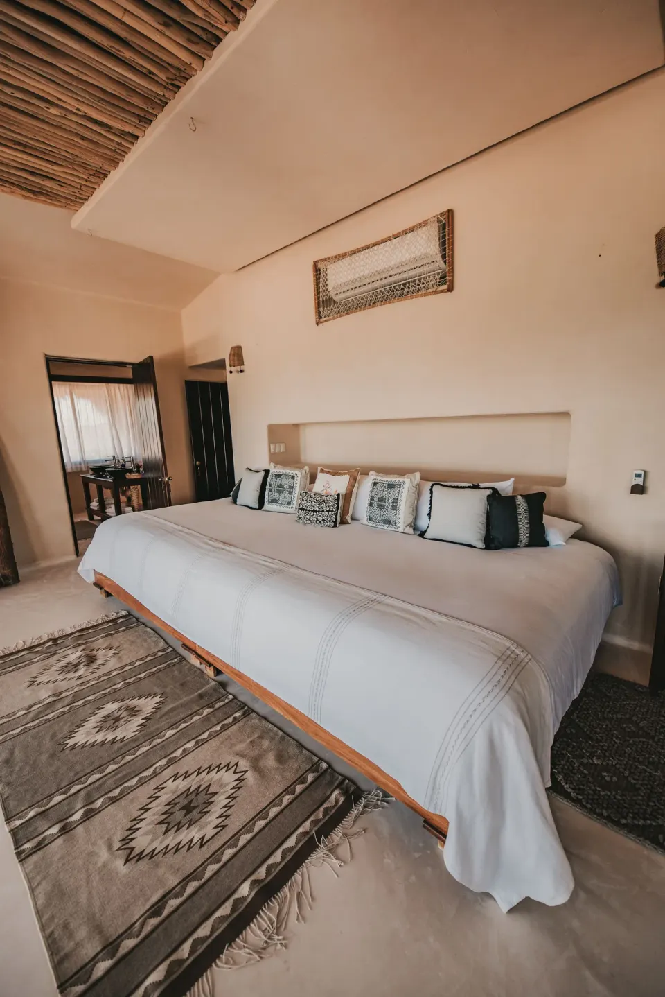 Spacious Casa Palapa guest room with king bed and textured ceiling at Papaya Playa Project