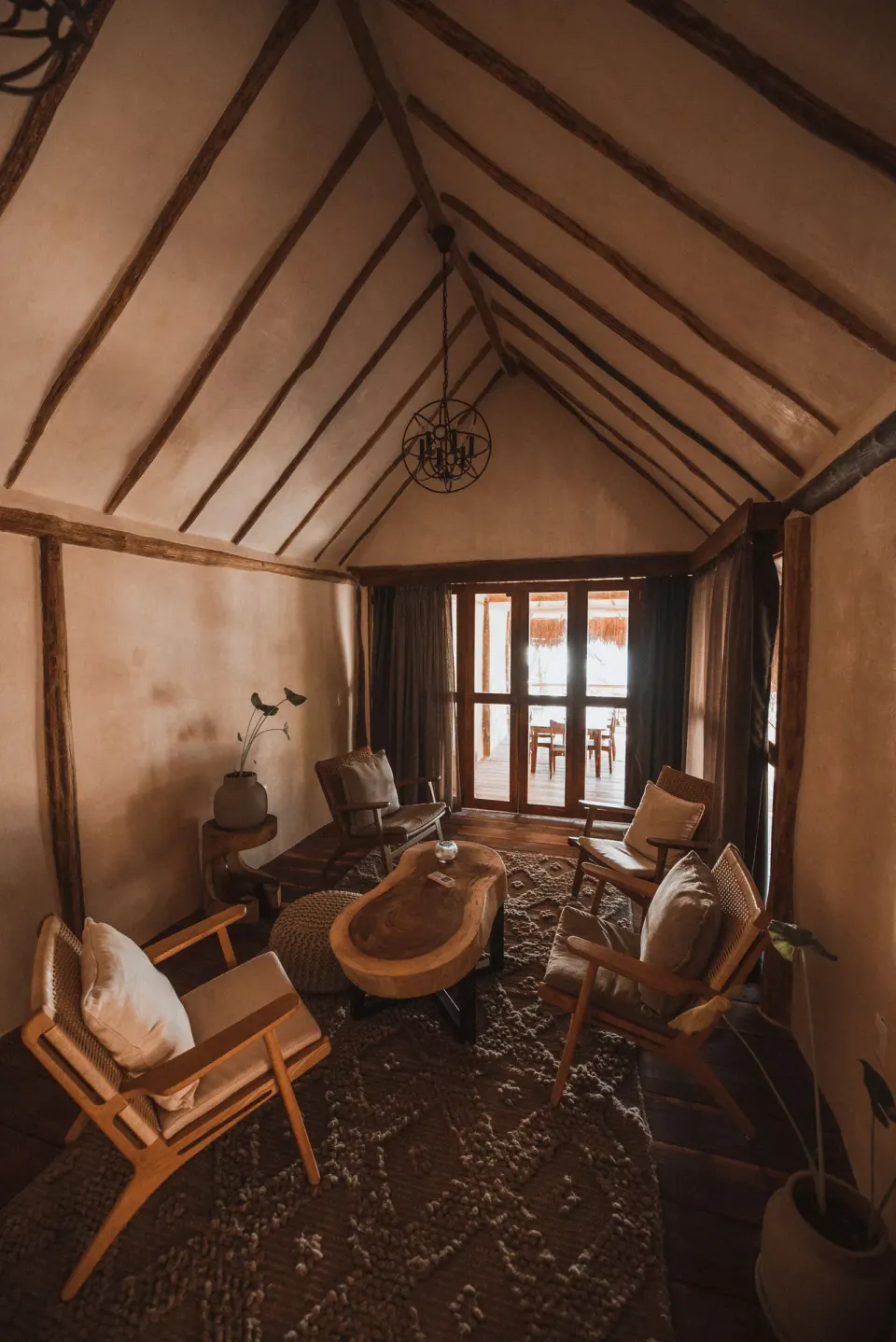 Seating cluster and balcony doors in Casa Palma lounge at Papaya Playa Project
