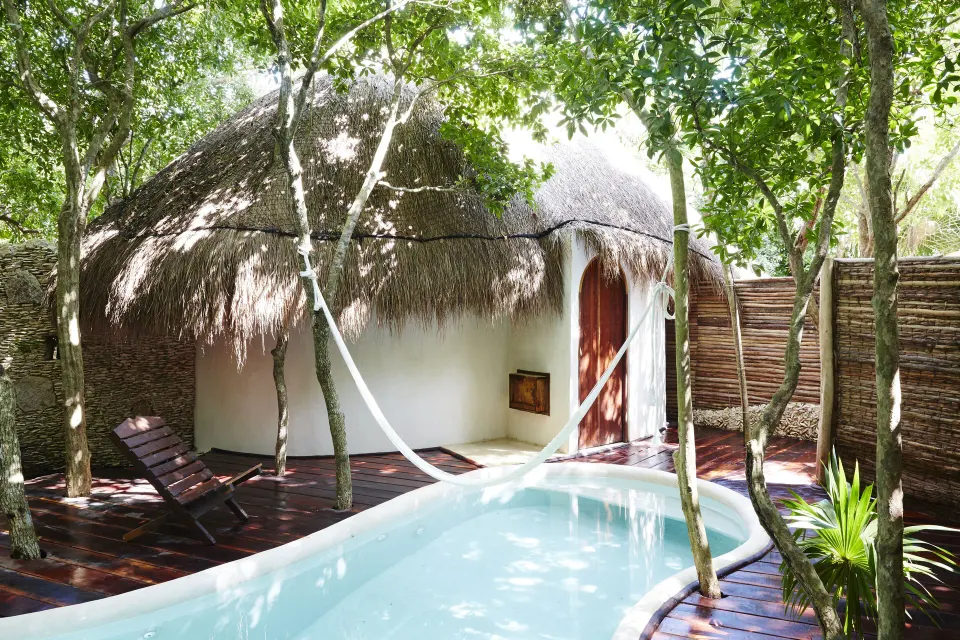 Private casita with a ground-level plunge pool and hammock at Papaya Playa Project