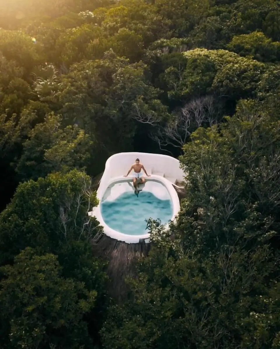 Private casita pool surrounded by jungle at Papaya Playa Project with a guest sitting on the edge