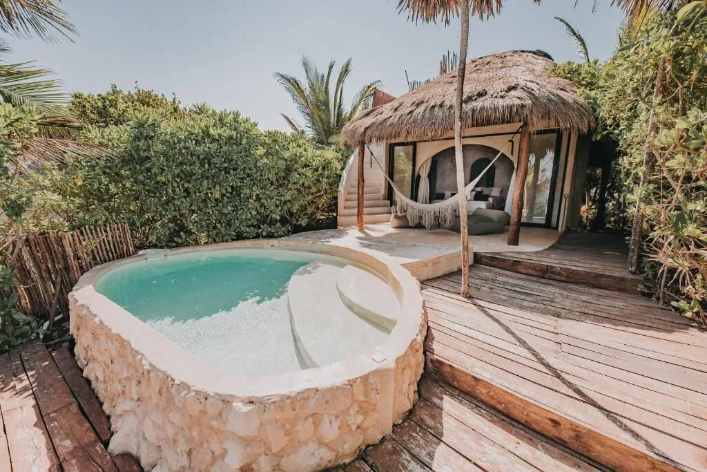 Private curved plunge pool and deck outside a casita at Papaya Playa Project