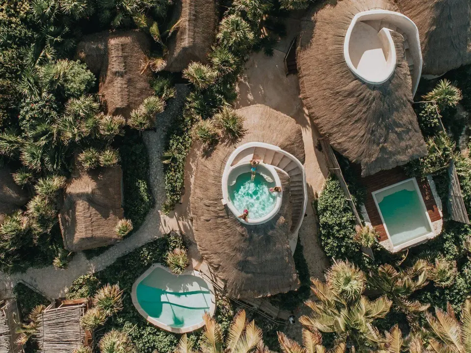 Aerial view of casitas with circular rooftop plunge pools and private pools at Papaya Playa Project