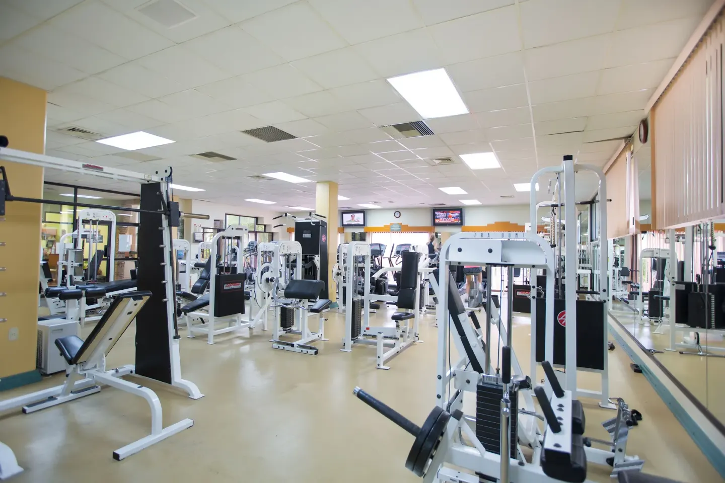 Fitness center with strength machines and mirrors at Paradise Village Beach Resort and Spa.